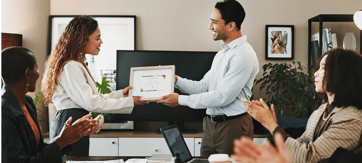 Award presentation in a professional office setting.