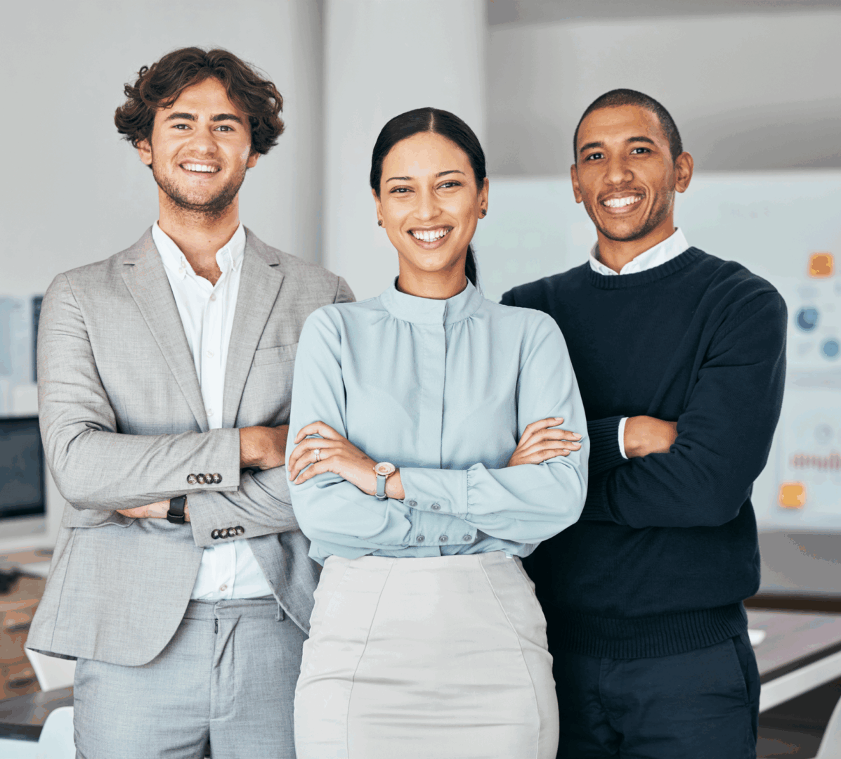 Three professionals smiling in an office.