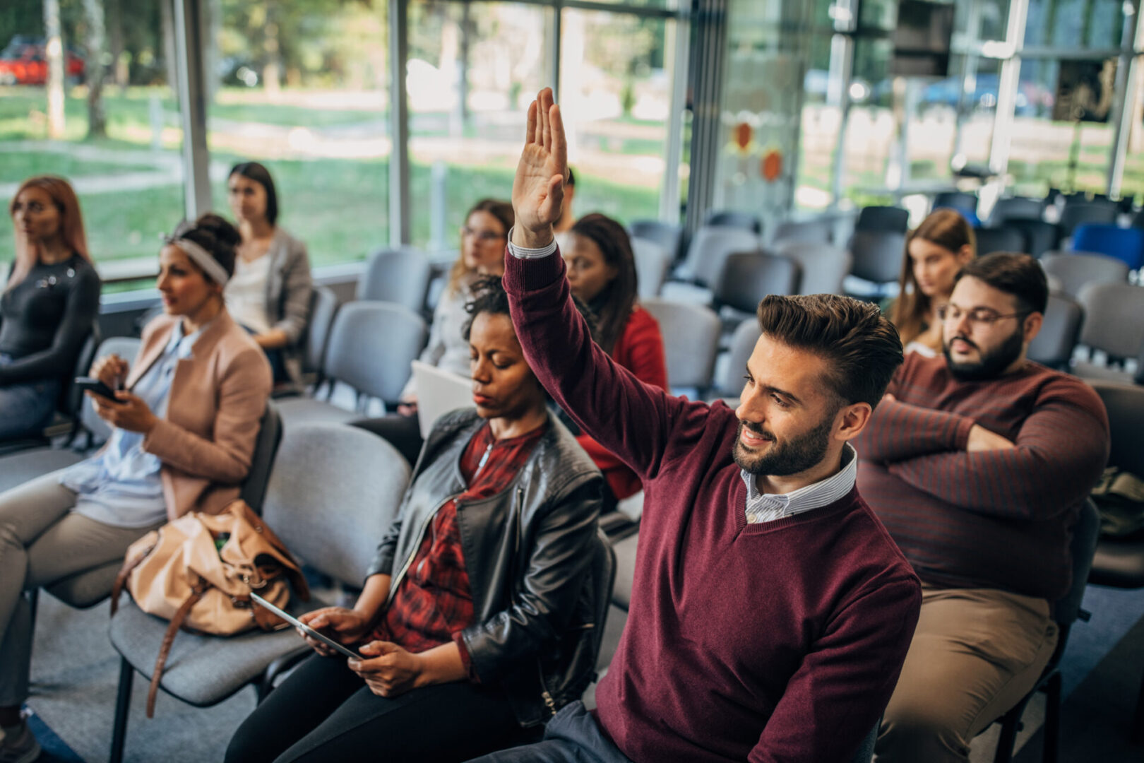 Group of people sitting at a business presentation/conference.