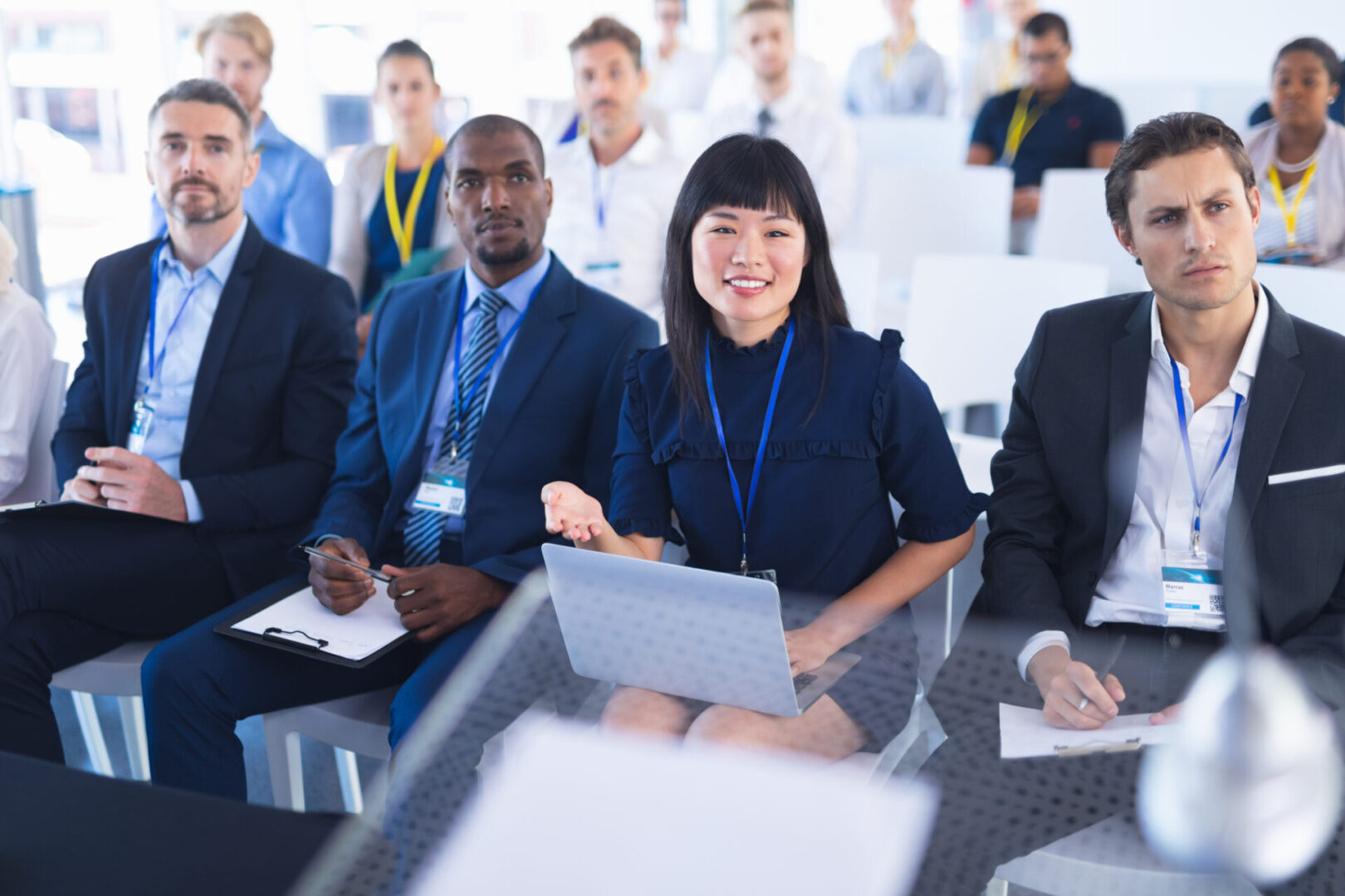 Front view of diverse Business people attending business seminar in conference meeting. International diverse corporate business partnership concept