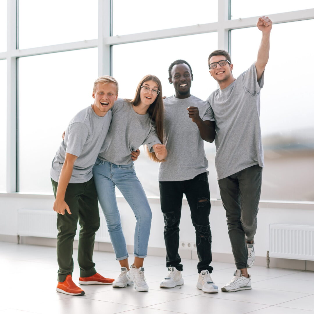 happy young employees standing in new office. the concept of teamwork