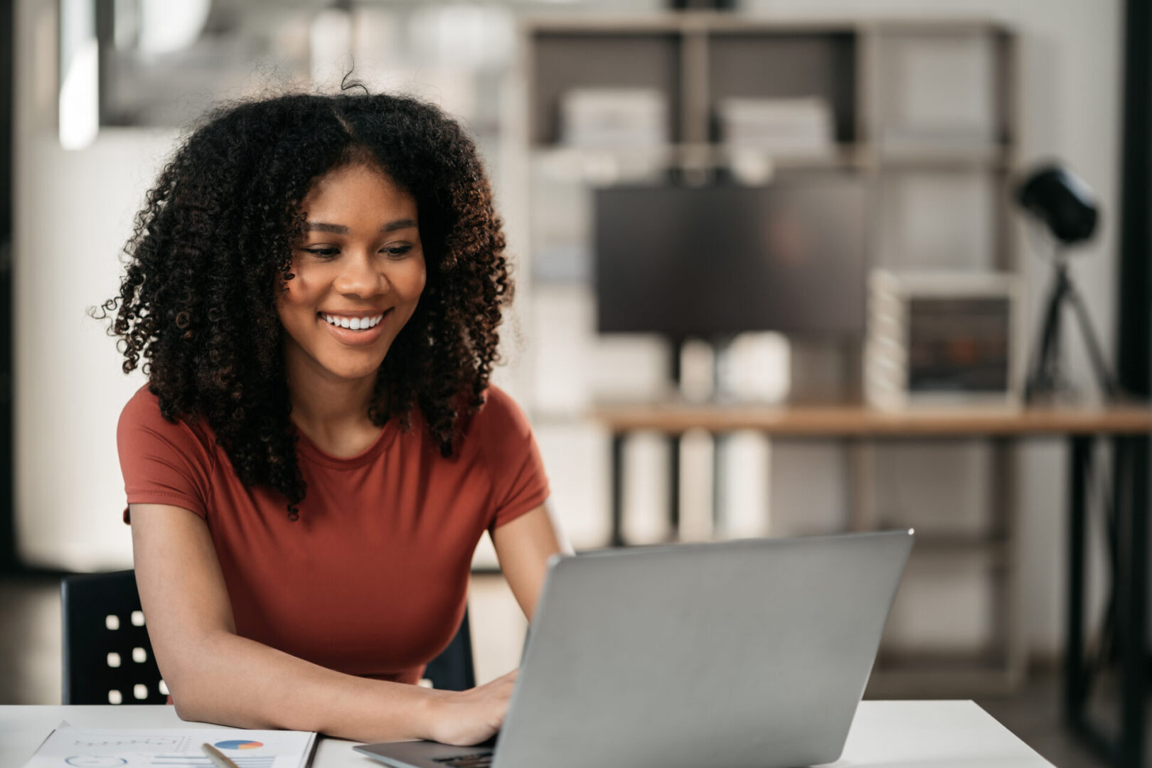 Businesswomen hand working with tablet and laptop computer with documents on office desk in modern office.