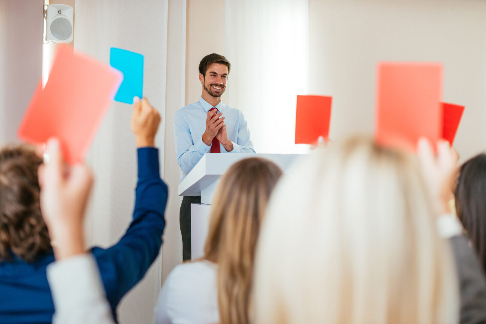 Group of people attending on seminar or workshop in modern conference hall and gaining new skills and knowledge.