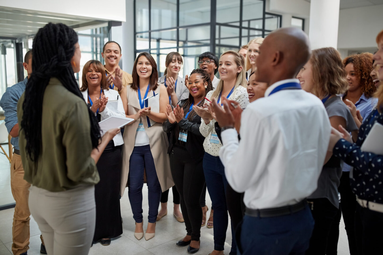 Shot of a young woman delivering a presentation to a group of businesspeople in a office